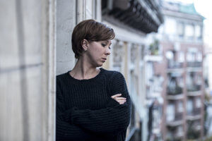A woman looks out the window thinking about the best eating disorder treatment programs