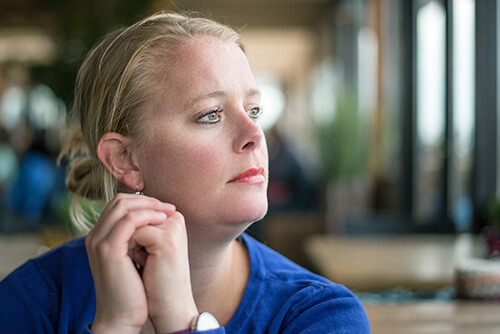 binge eating disorder treatment programs A woman thinks about calling binge eating disorder treatment programs