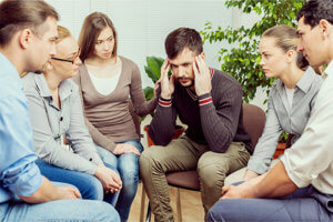 Group comforts man at a drug rehab in PA