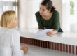 woman talking to receptionist about finding an outpatient drug treatment center